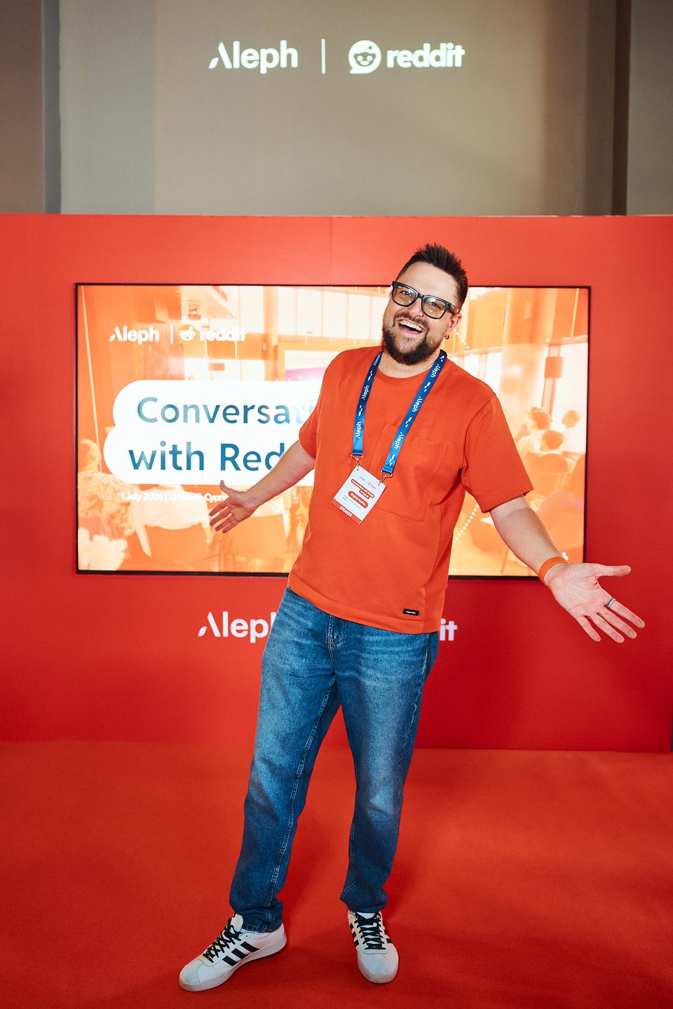 Evgeny Kozlov in front of the Aleph and Reddit “Conversations with Reddit” backdrop in Limassol, Cyprus